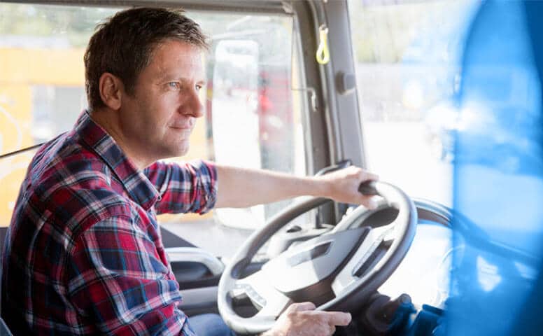 Truck Driver Safety Commercial truck driver focused at the wheel during daytime route