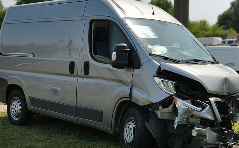 Van Accident Damaged fleet van with front-end collision and side dents