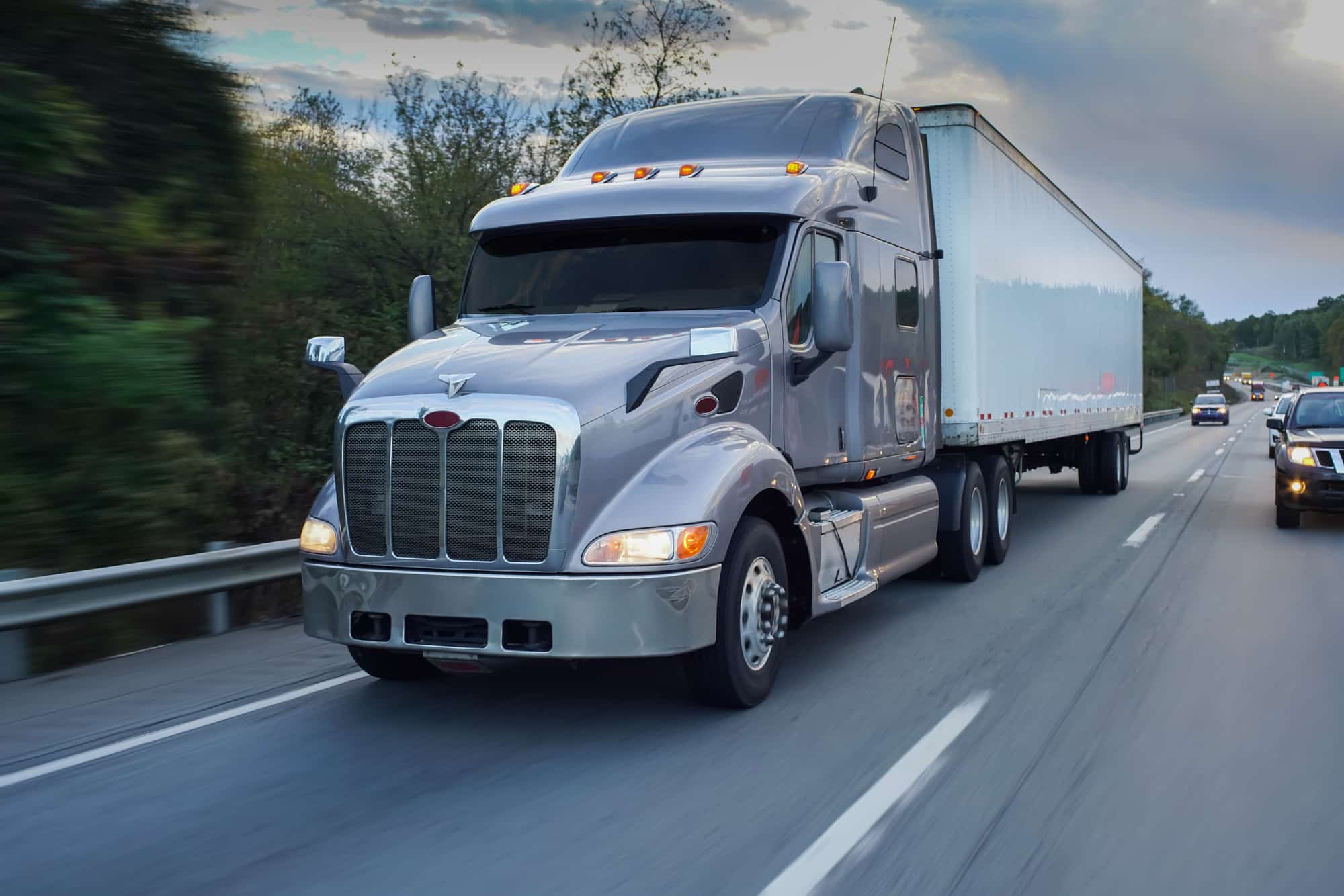 Semi truck driving on a highway, representing fleet vehicle operations and modern trucking safety technology
