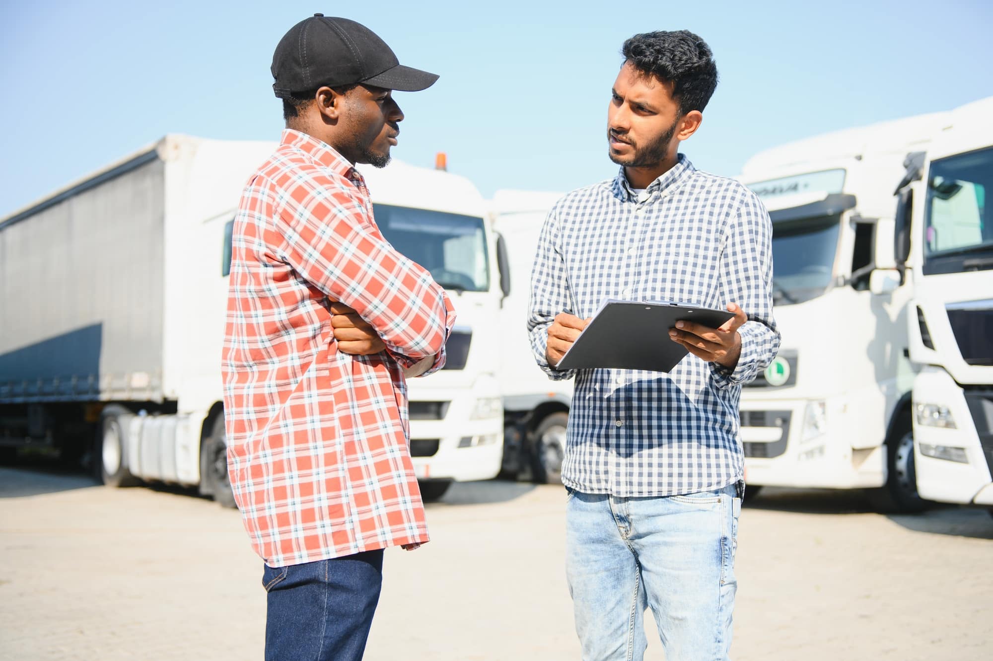 Fleet safety manager coaching a truck driver at the yard